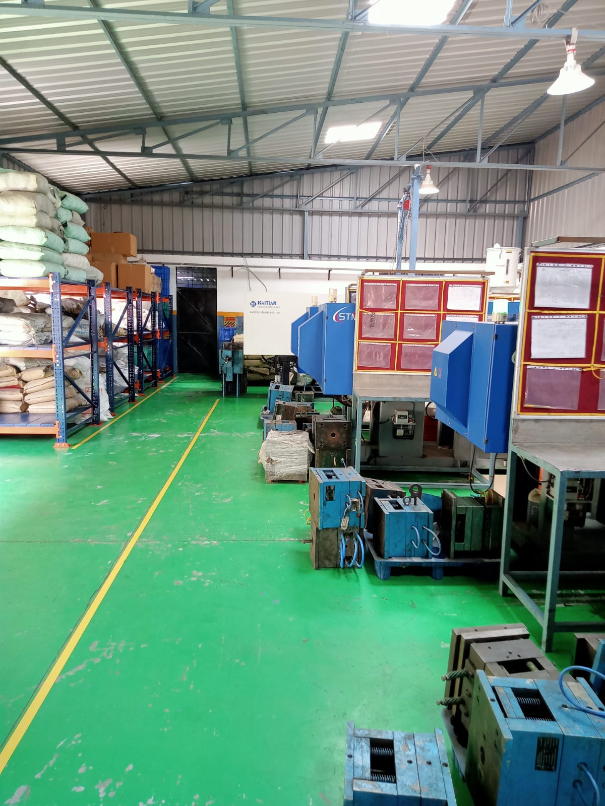 NEXA PLASTICS production floor with Haitian injection presses and raw material inventory